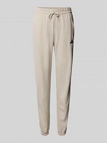 Spodnie dresowe o kroju slim fit z detalem z logo adidas Sportswear szare damskie EAN KB8511