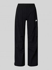 Spodnie materiałowe o kroju wide fit z nadrukiem z logo adidas Sportswear czarne damskie EAN JL5081